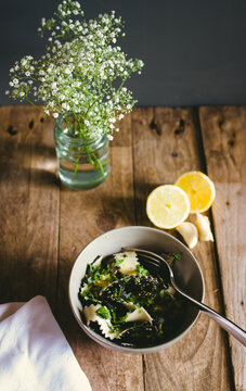 A bowl of bi-coloured pasta with gremolata sauce.