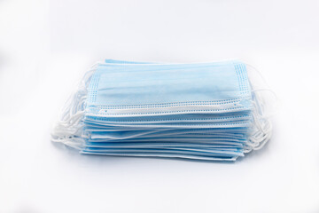 Blue medical face masks prevent dust and coronavirus, COVID-19, many pieces isolated on white.