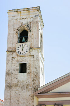 Ancient tower clock on the outside of a medieval church