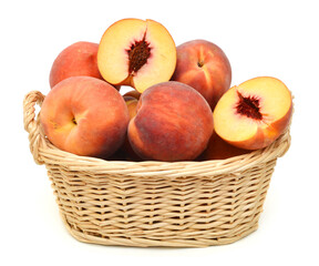 sweet peaches in basket on a white background