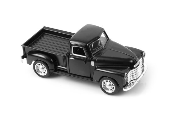 Studio shot of black old style model pickup truck .