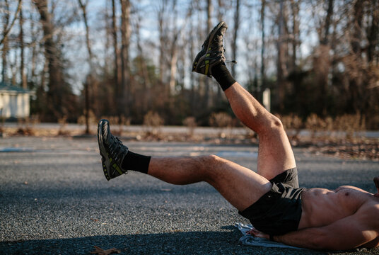 Legs and torso of strong athlete doing body weight training excercise