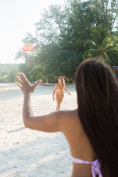 Two Friends Playing Frisbee on the Beach