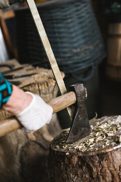 Senior woman using an axe on the log