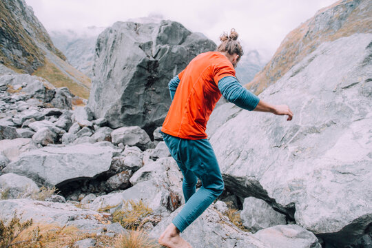 Young man travels down the side of a mountain