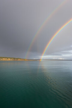 double rainbow over the ocean in the early morning