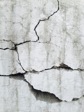 Large gaping cracks on a wall.