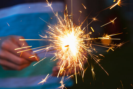 Girl Lighting One Sparkler Off Of Another