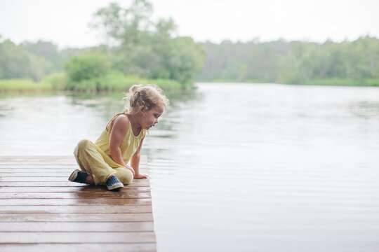 little girl exploring on a dock