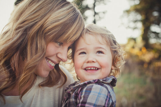 Young mother holds child with love