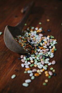 Dried mixed beans and split peas with a wooden spoon.