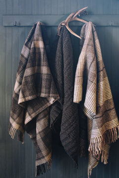 Blankets hanging on coat hooks with antlers