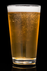 Frosty pint of amber ale lager pilsner microbrew craft beer glass isolated on black background