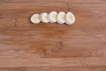 Banana sliced on a cutting board; banana prepared for a snack