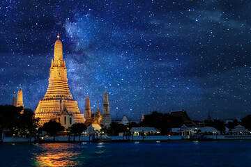 Night time view of Wat Arun Temple in bangkok Thailand  and Milky way galaxy stars and space dust...