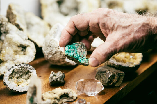 Man holding raw emerald