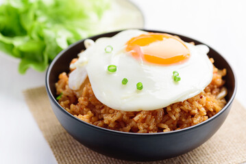 Korean food, Kimchi fried rice with fried egg on top in a bowl