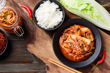Kimchi cabbage on plate eating with cooked rice on wooden table, Korean food