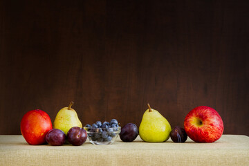 Still life of pear, plums, apple, blueberries and nectarine in a group; painting like effect of a bunch of fruit
