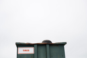 Dumpster filled with tires at a recycling center