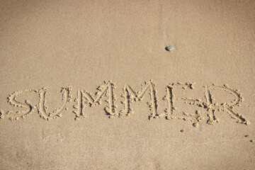 Inscription summer on sand at beach. Vacation time