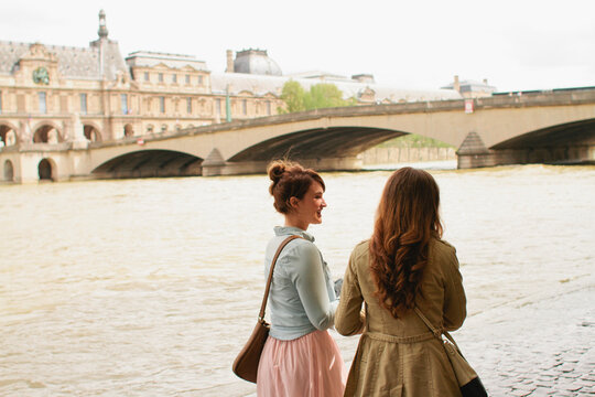 Two young women walk around Paris France