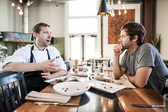 Chef and shift manager conversing after a meal