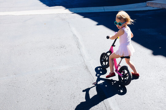 Cute Little Girl Riding a Pink Bike