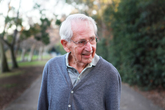 Portrait of elderly man in button up sweater outdoors