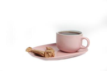 a cup of tea on a saucer and stickjaws isolated on white background