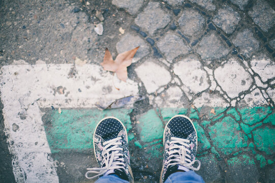 Woman's shoes on colorful path.