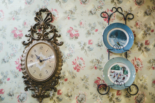 vintage clock and plates hanging on wall