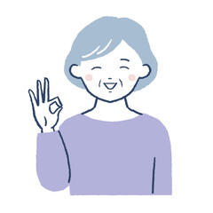 笑顔でOKポーズをするシニア女性