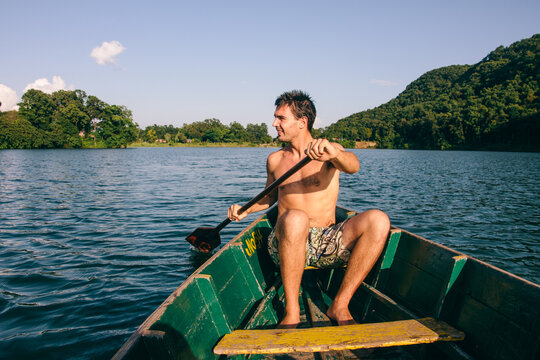 Man rowing on a boat on a lake