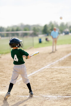 baseball player hitting the ball