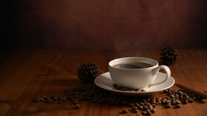 Cup of hot coffee with coffee beans decorated on on wooden table