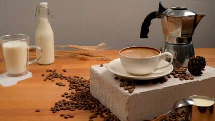 Coffee table with coffee cup, coffee pot and milk decorated with coffee beans and wheat