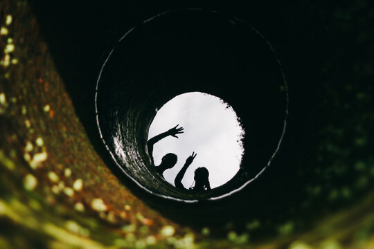 Reflection of two men silhouette on a well