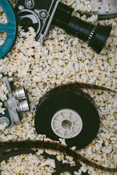 Cinema cameras, reels and popcorn.