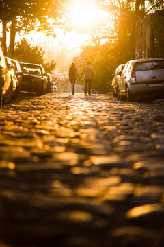 Love couple walking on the street in sunset