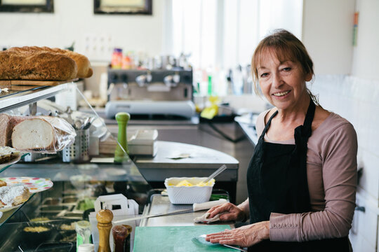 Woman working in a bakery making sandwiches