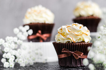 Homemade cupcakes with caramel syrup and cream cheese