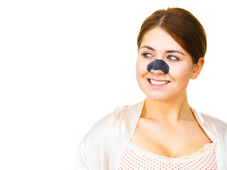 Woman applying pore strips on nose