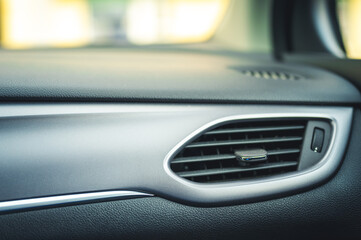 Fototapeta na wymiar Modern car interior: steering wheel, gearshift lever, multimedia system. Car air condition.