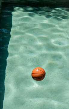 Basketball floating in a pool