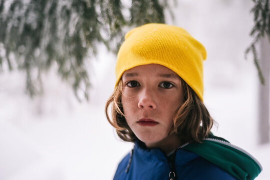 Young boy portrait in the snowy woods