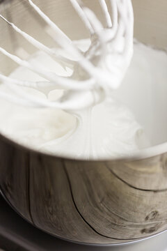 Egg whites whisked to stiff peaks stage in food mixer