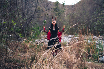 Woman Wearing Rabbit Mask and Holding Candles