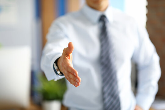 Businessman holds out his hand for a handshake