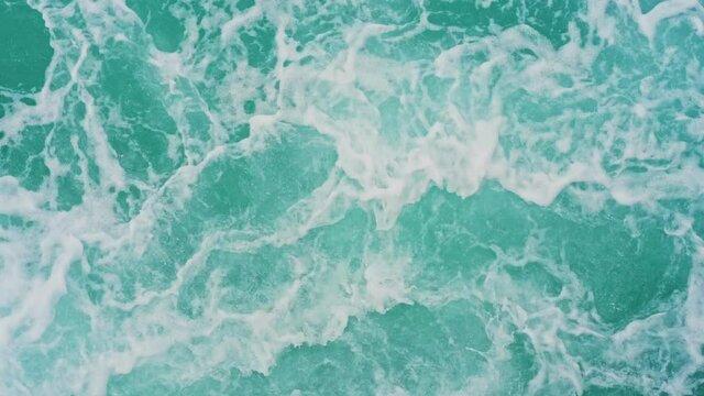 Blue water streams from a boat